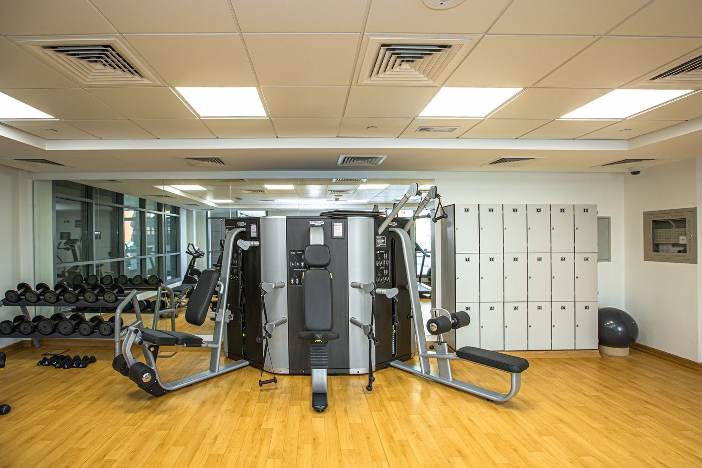 Different exercise stations arranged across a gym floor.