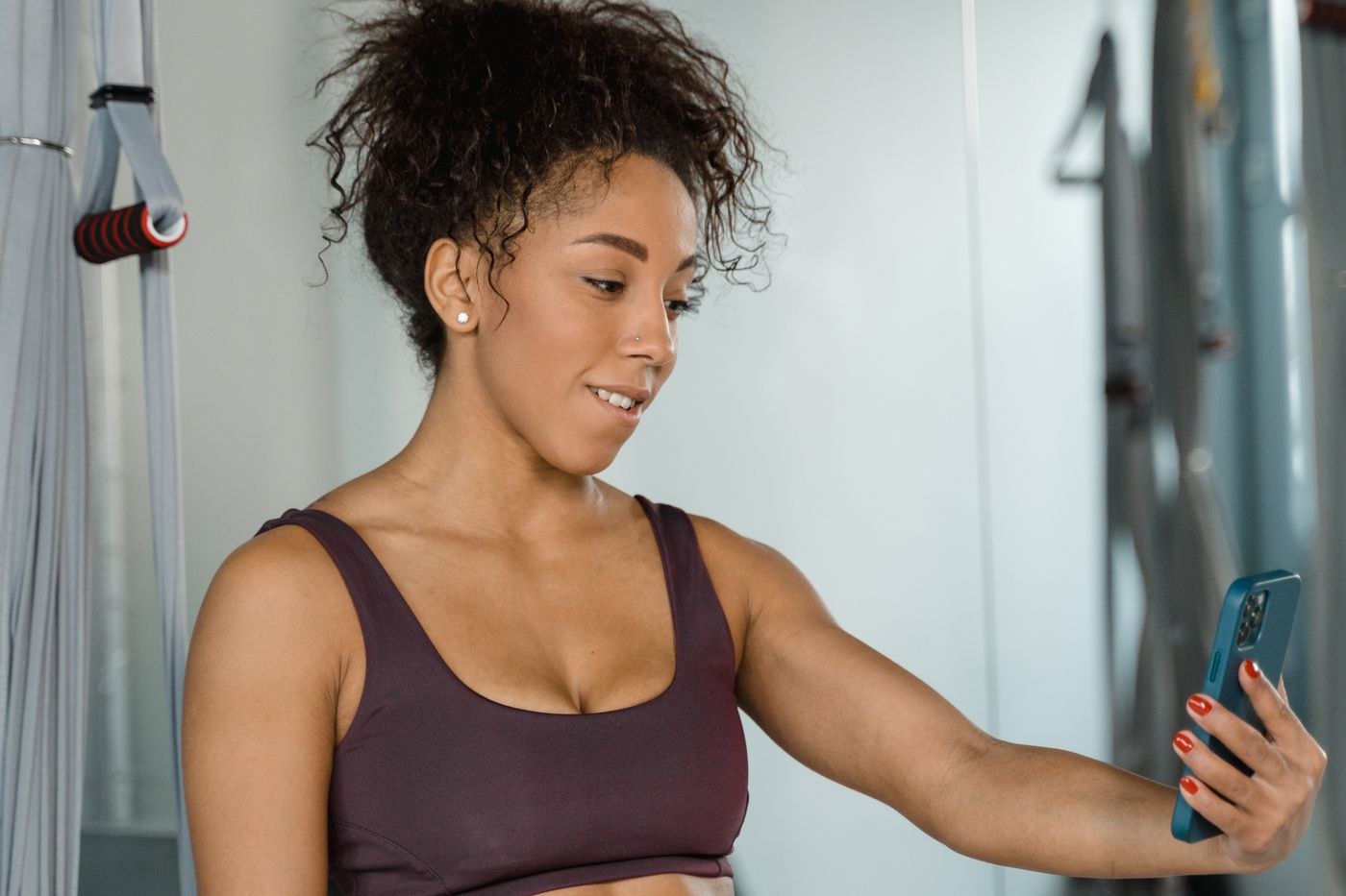 A woman in exercise clothing checking a smartphone.