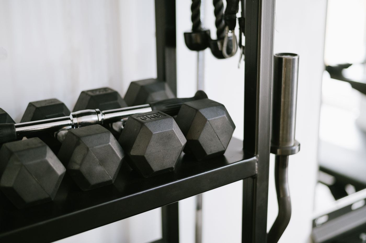 Dumbbells stored securely on a rack above the floor.