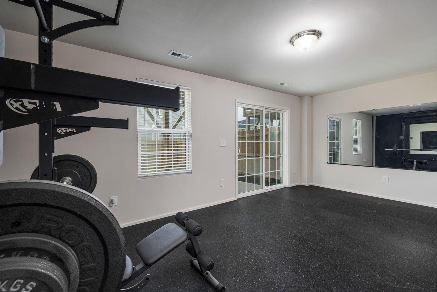 A clear indoor exercise floor with equipment set back to one side.