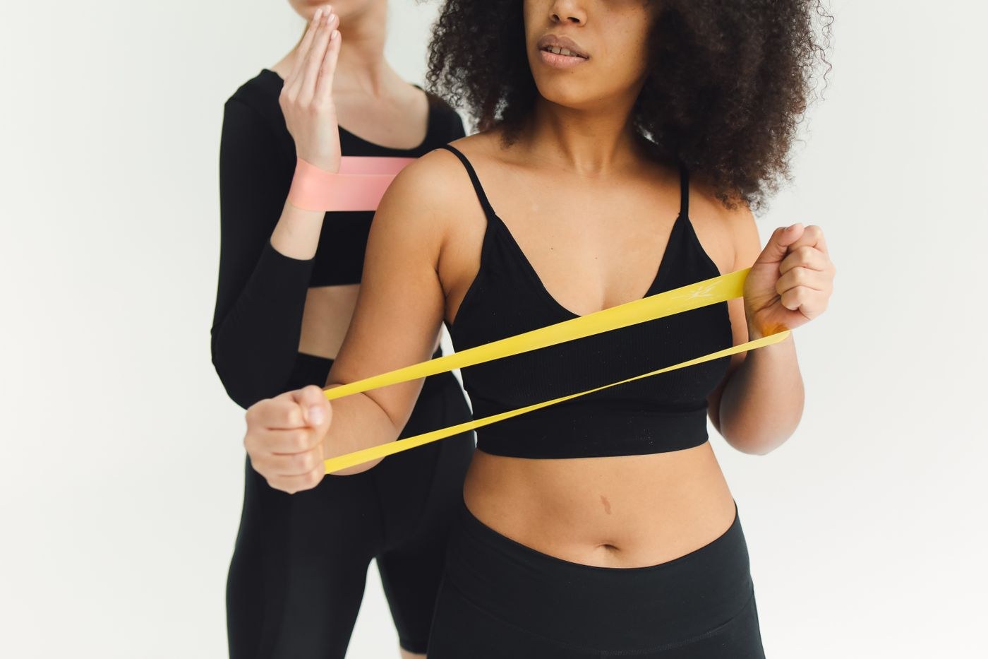 A short elastic loop stretched between a woman’s hands.