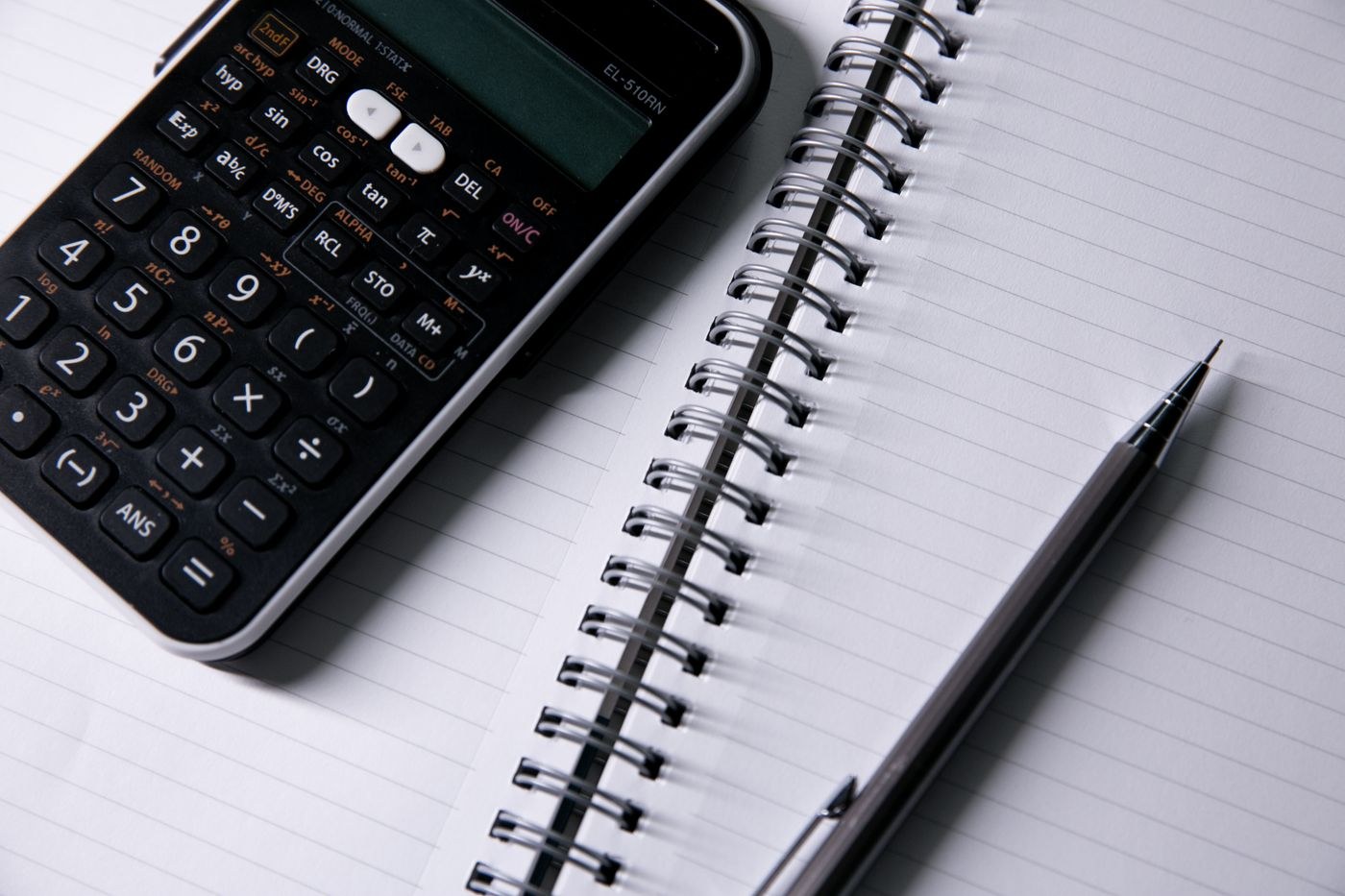 A calculator, notebook and pen for working through costs.