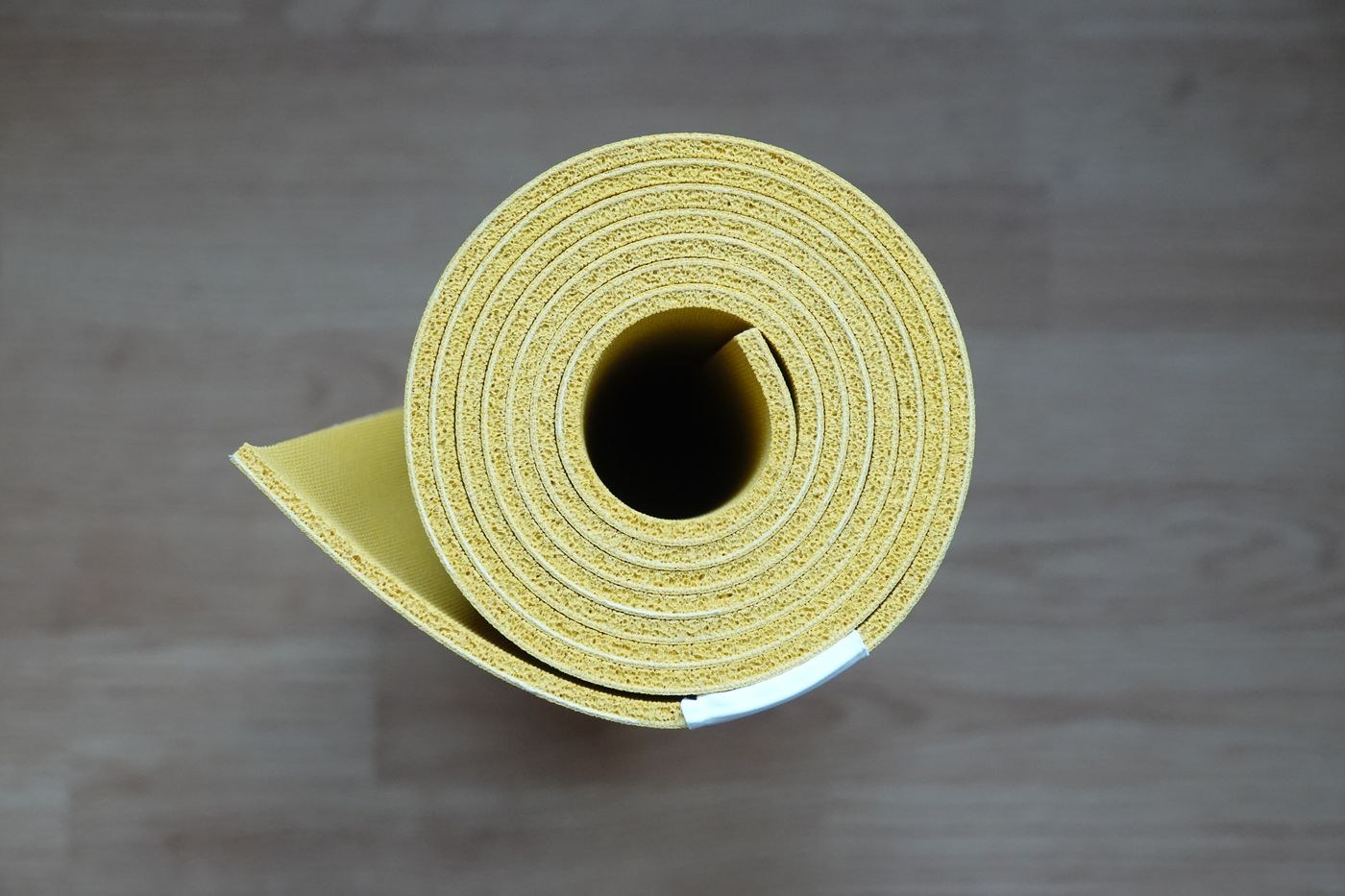 An exercise mat rolled up between sessions.