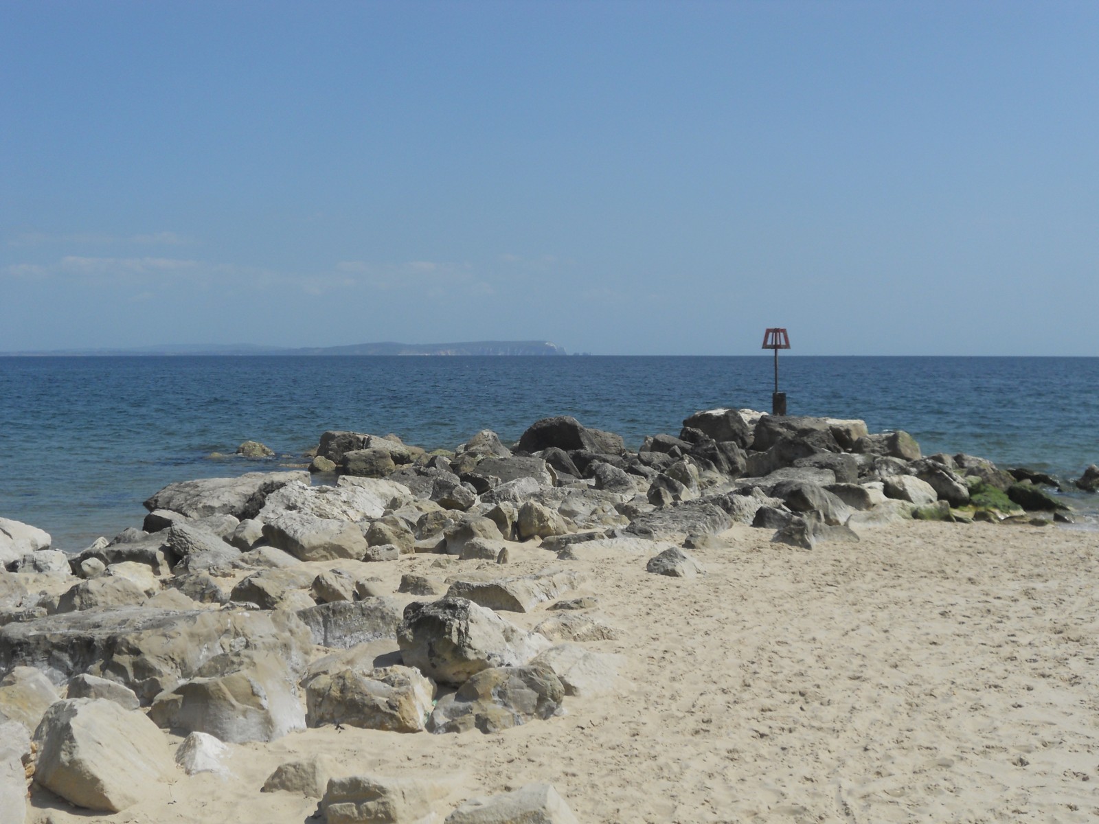 A rock groyne beside the beach at Hengistbury Head.