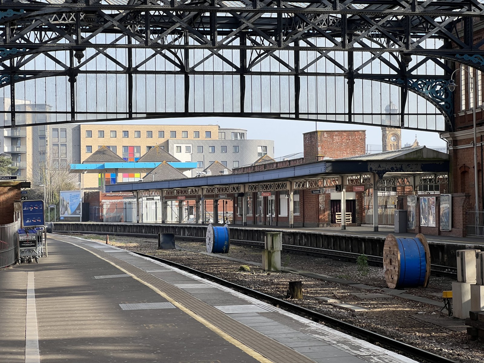 Platforms beneath the glass and iron roof of Bournemouth railway station.
